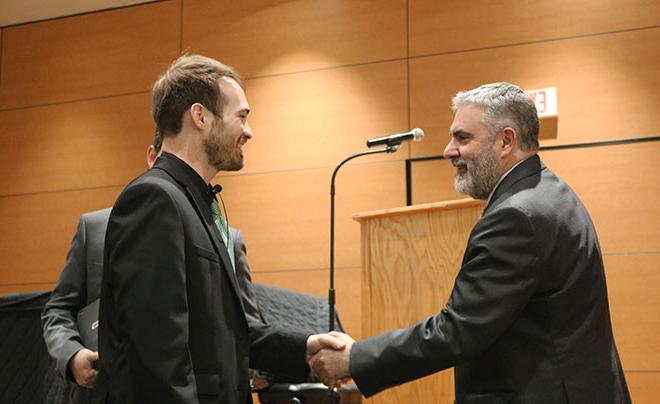 Rerick shaking hands with Dr. Clavere